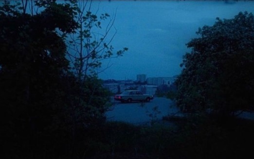 a car parked in a parking lot at night