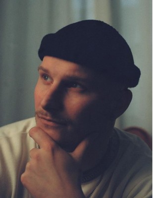 a man wearing a black hat and a white shirt