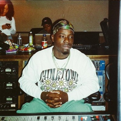 a man sitting in front of a mixing desk