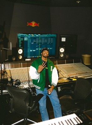 a man standing in front of a mixing desk