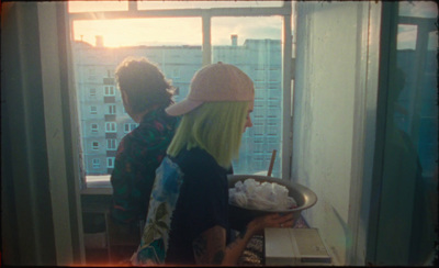 a couple of women standing in front of a window