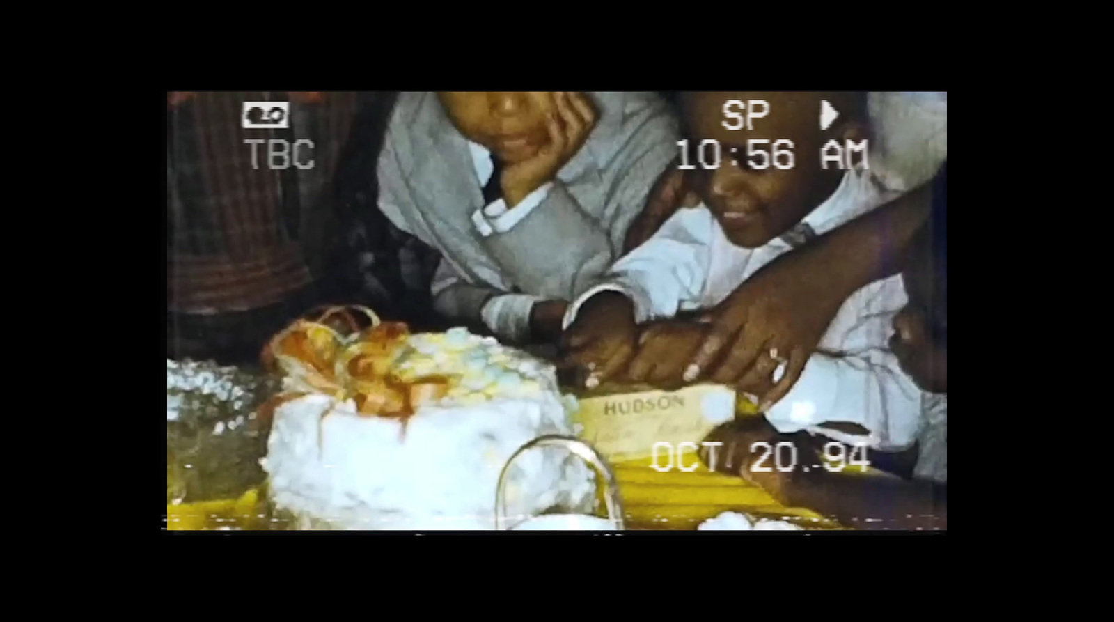 a couple of people sitting at a table with a cake