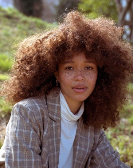 a close up of a person with an afro