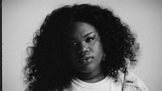 a black and white photo of a woman with curly hair