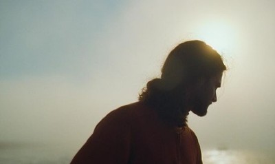 a man standing in front of a body of water