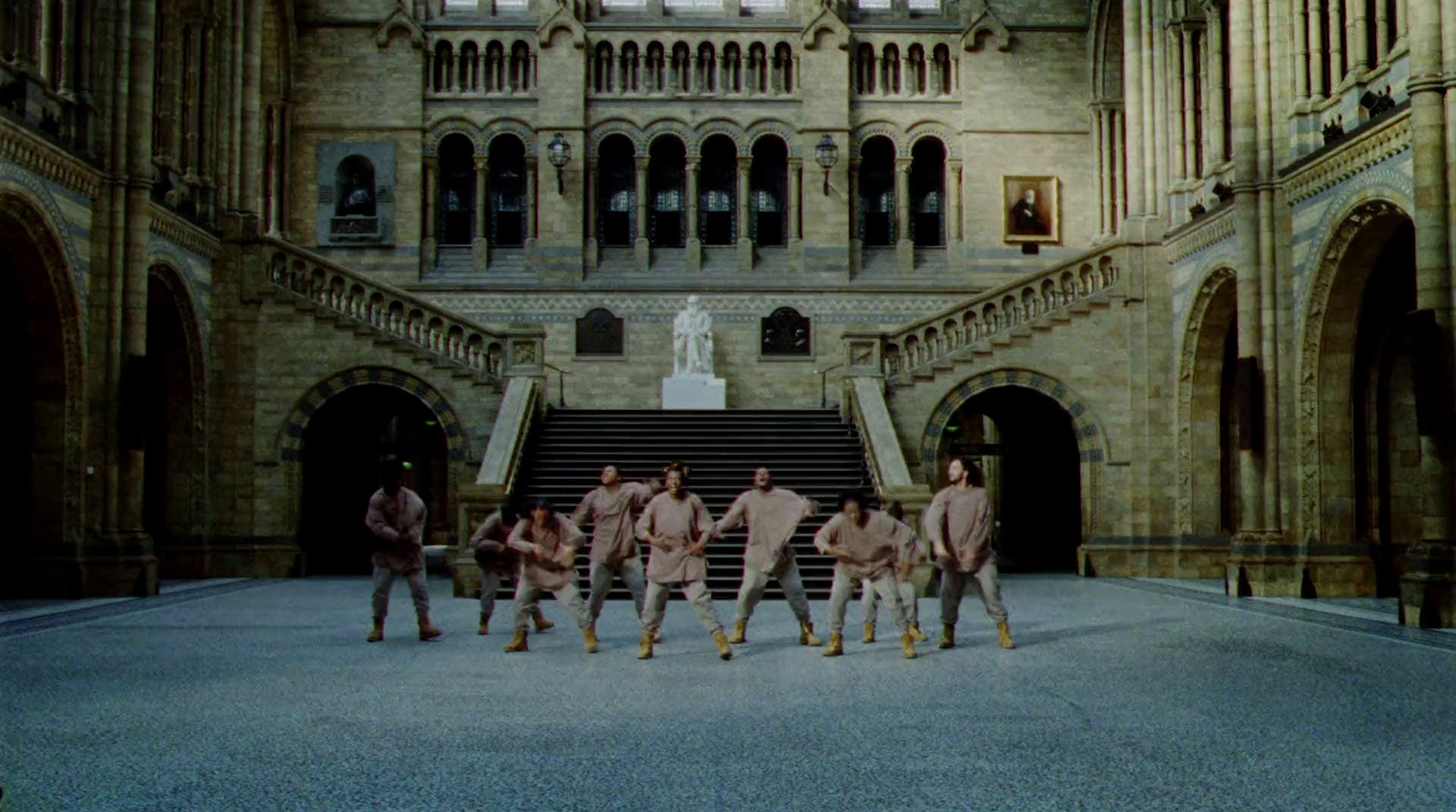 a group of men standing in front of a building