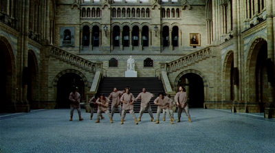 a group of men standing in front of a building