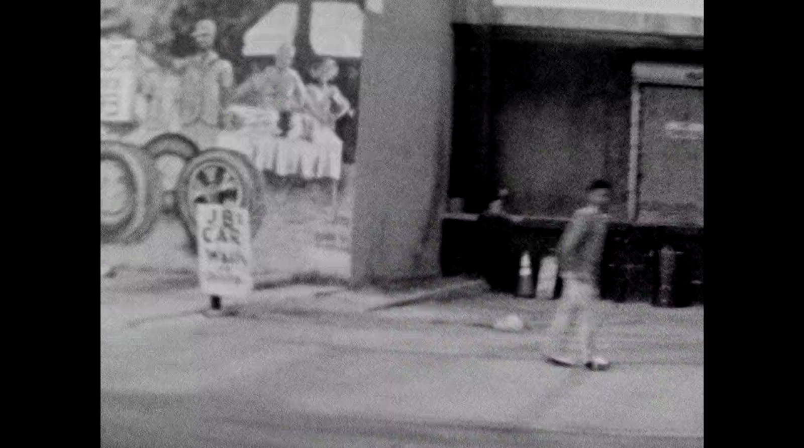 a black and white photo of a man on a skateboard