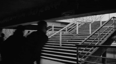 a black and white photo of people walking up stairs