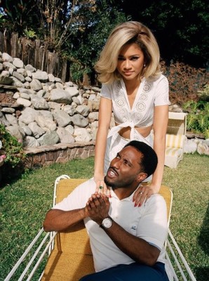 a man sitting on top of a chair next to a woman