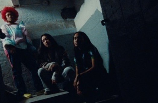 a group of young women sitting on top of a set of stairs