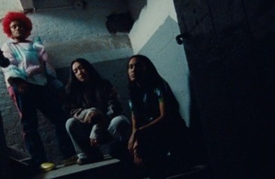 a group of young women sitting on top of a set of stairs