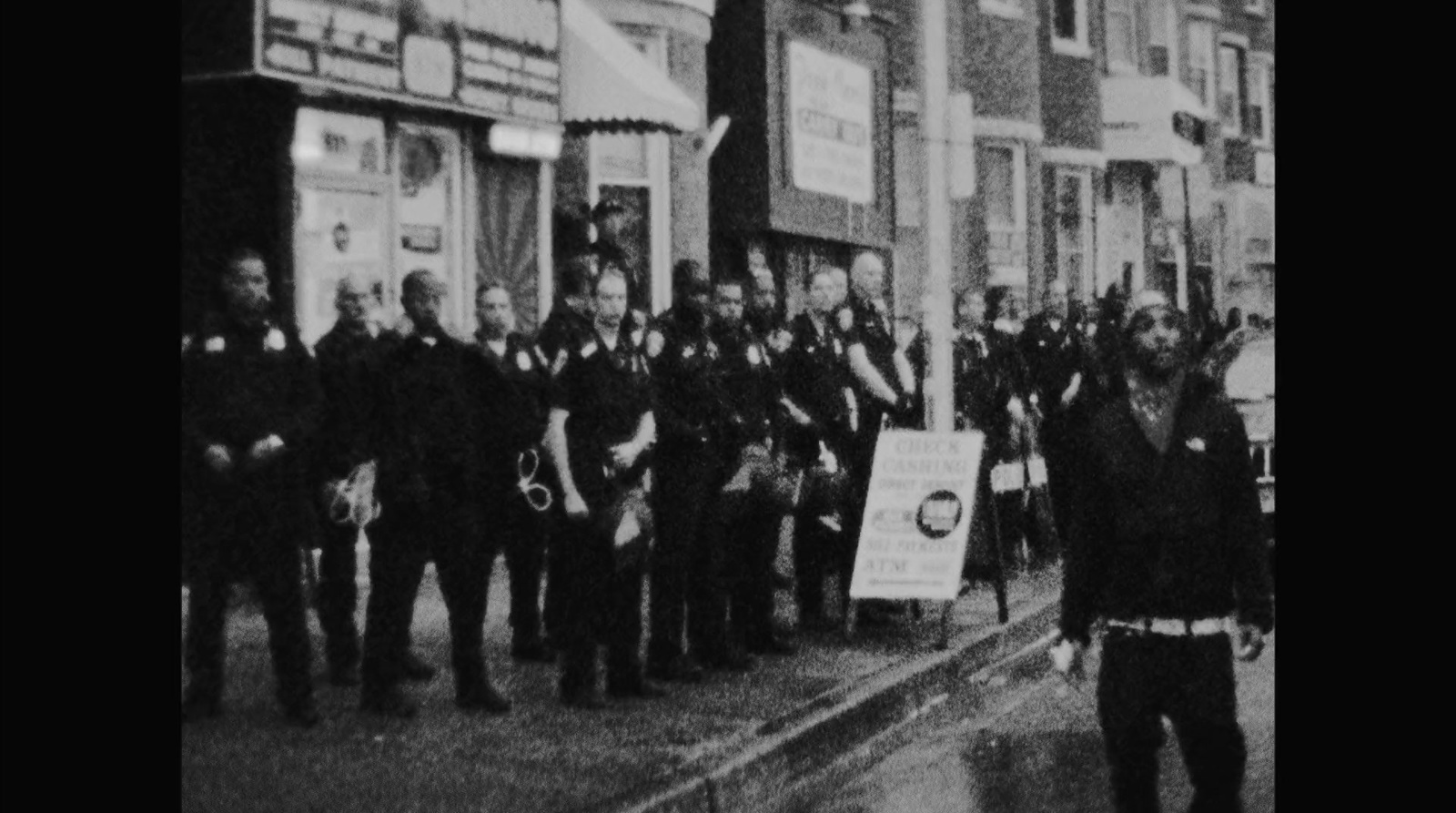 a group of men standing on the side of a road