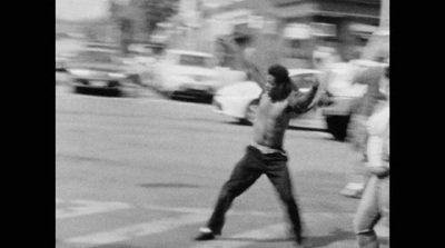 a black and white photo of a man throwing a frisbee