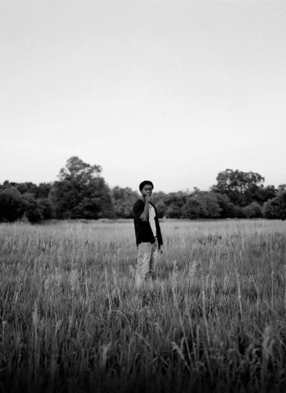 a man standing in a field of tall grass