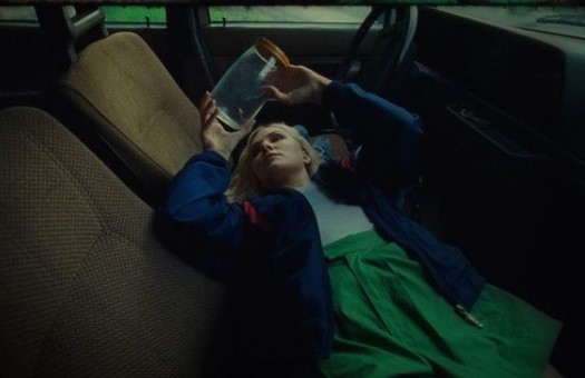 a woman laying in the back seat of a car