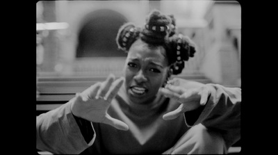 a black and white photo of a woman making a face