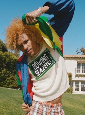a man with red hair wearing a colorful jacket