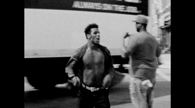 a black and white photo of two men walking down the street