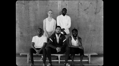 a group of men sitting next to each other on a bench