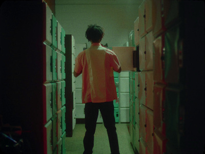 a person standing in a room with a bunch of boxes