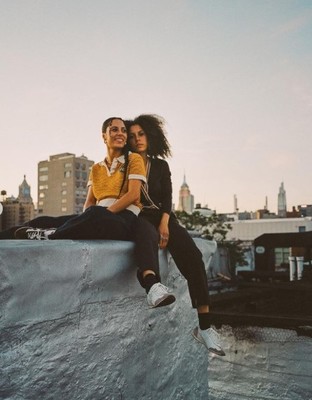 a couple of people that are sitting on a ledge