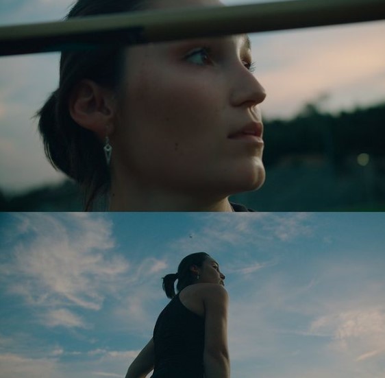 a woman standing in front of a blue sky