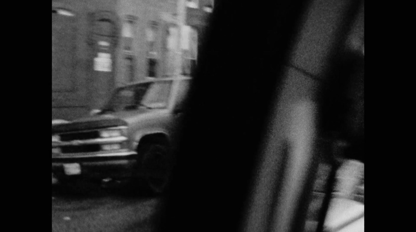 a black and white photo of a truck on a city street