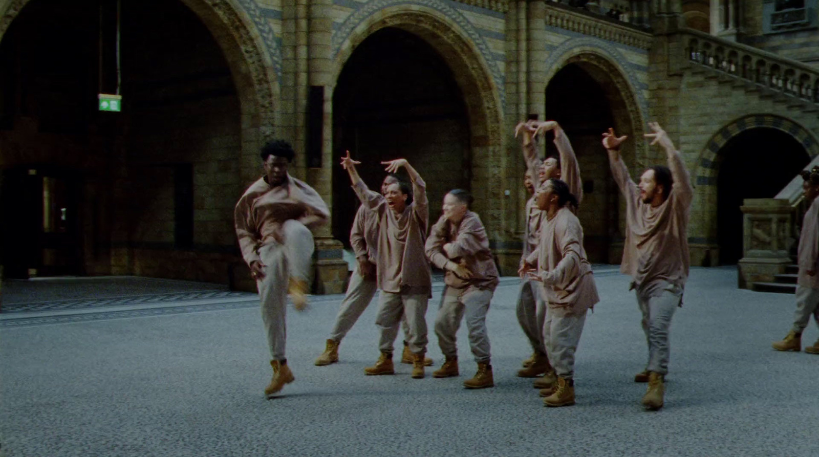 a group of people dancing in front of a building