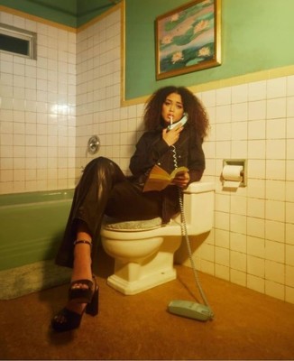 a woman sitting on a toilet in a bathroom