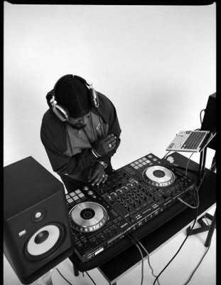 a man that is sitting at a dj's desk