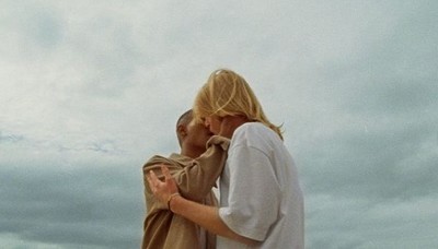 a man and a woman standing on a beach