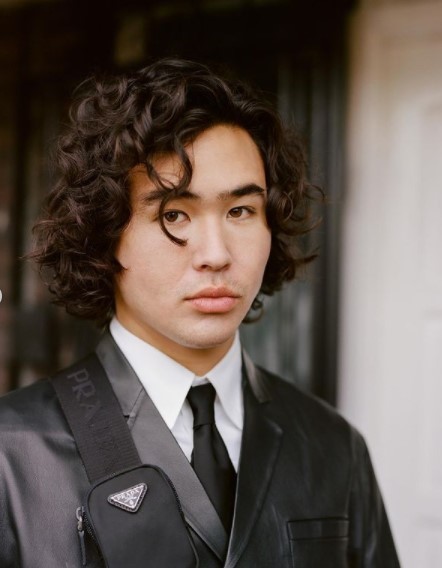 a young man wearing a suit and tie