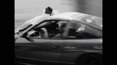 a person sitting on the hood of a car