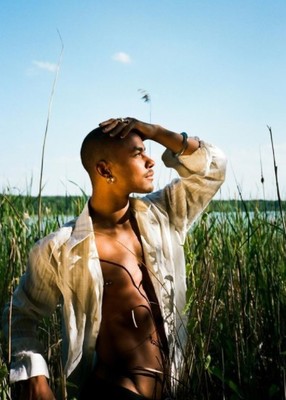 a man standing in a field of tall grass