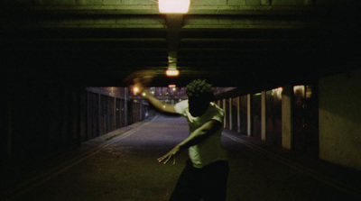 a man is skateboarding in a dark tunnel