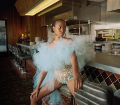 a woman sitting on a counter in a restaurant