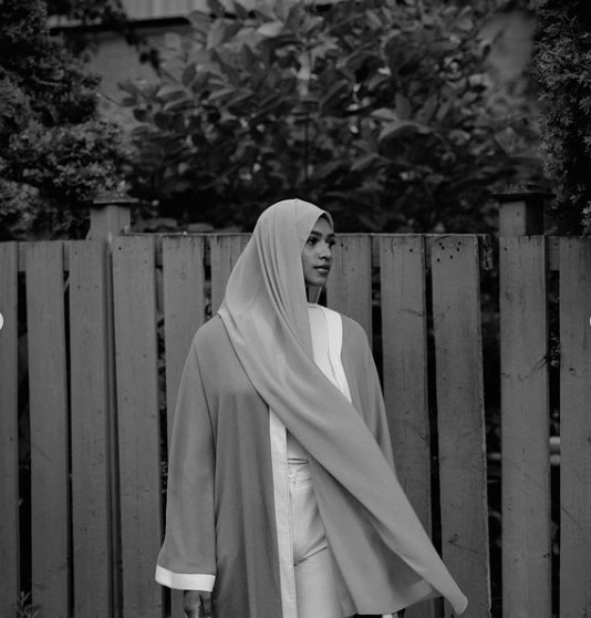 a woman in a nun outfit walking down the street