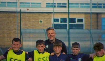 a group of young men standing next to each other on a soccer field