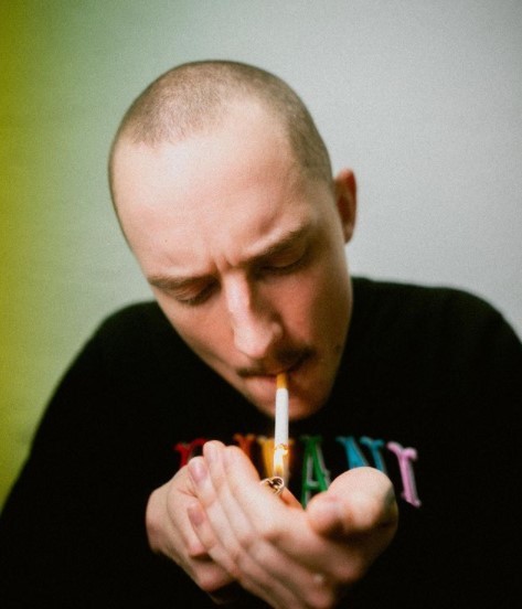 a man holding a lit candle in his hands