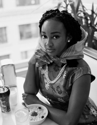 a woman sitting at a table with a plate of food