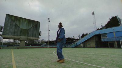 a man in a suit and tie standing on a tennis court