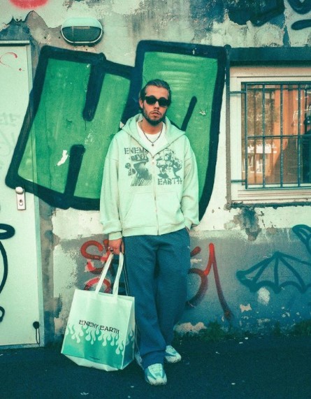 a man standing in front of a building with a bag