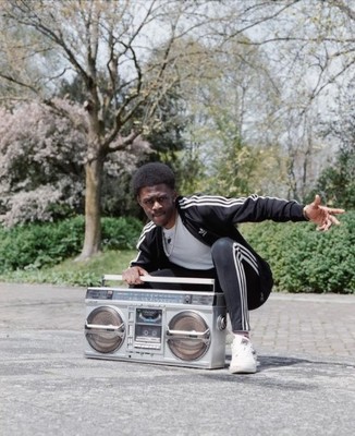 a man sitting on top of a boom box