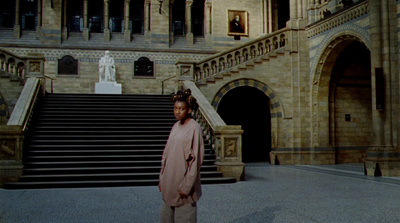 a woman standing in front of a large building