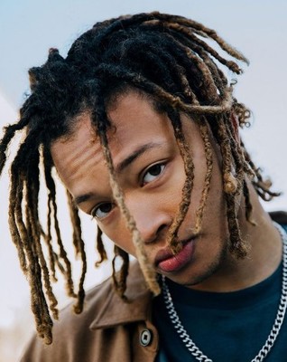 a close up of a person with dreadlocks