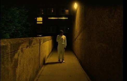 a man standing in a tunnel at night