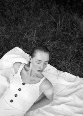 a woman laying on a blanket in the grass