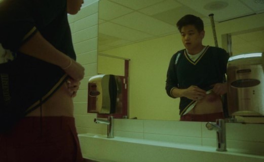 a man standing in front of a bathroom mirror