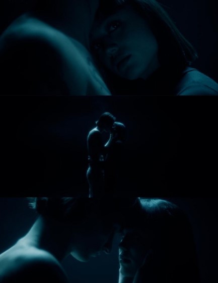 a man and a woman kissing in the dark